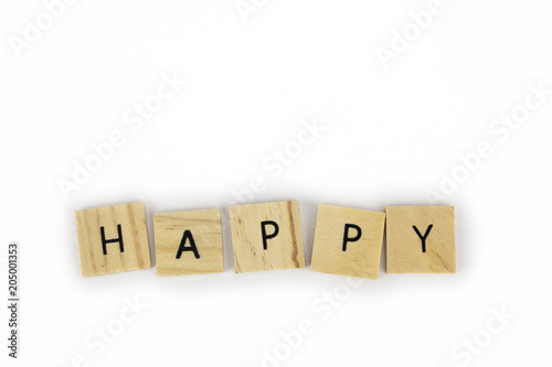 Wooden tiles spelling out the word happy on an isolated white background. Inspirational and motivational! 