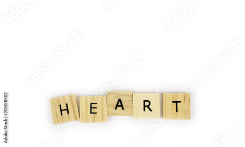 Wooden tiles spelling out the word heart on an isolated white background. Inspirational and motivational!  Room for text! 
