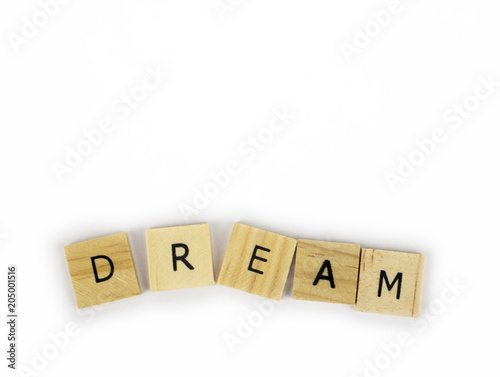 Wooden tiles spelling out the word dream on an isolated white background. Inspirational and motivational! 