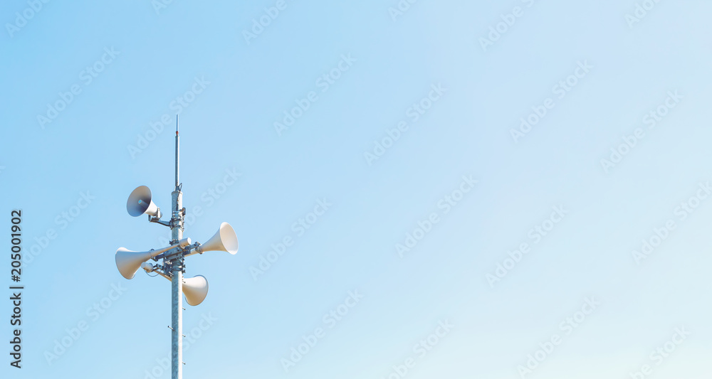 Outdoor loudspeaker alert system against a blue sky Outdoor loudspeaker alert system against a blue sky