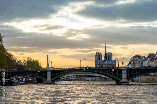 View of Notre Dame Cathedral from the Seine river during sunset