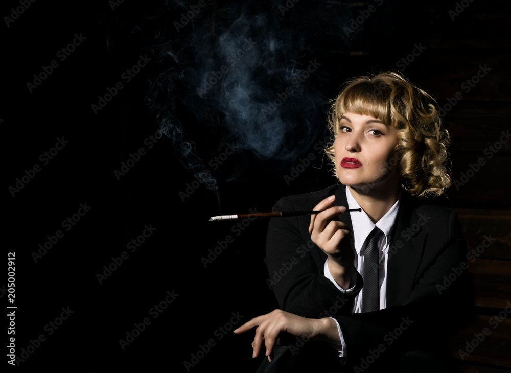 Fototapeta premium businesswoman with cigarette on a dark background, stylized retro portrait