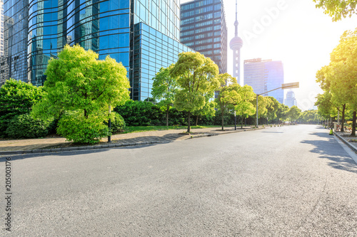 Fototapeta Naklejka Na Ścianę i Meble -  empty asphalt road and modern commercial office buildings in shanghai