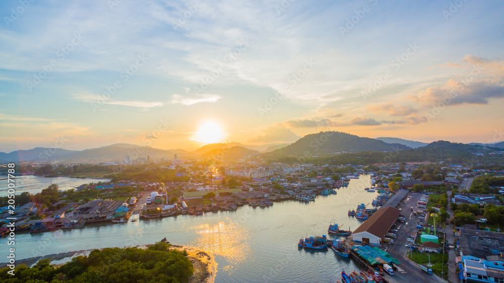 aerial scenery sunset at Siray  fishing port. Phuket Fishing Port is the largest fishing port. Located in Sire Island, next to Phuket Island. There is a large canal leading to the sea.