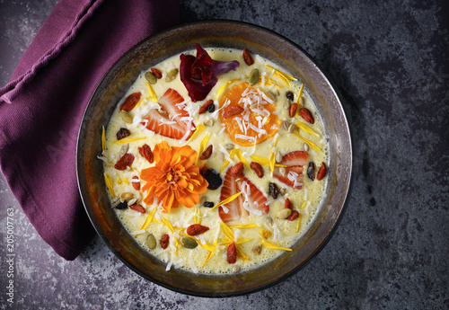 mango smoothie bowl on concrete table