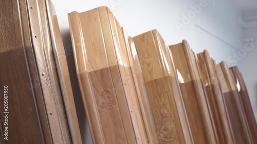 Low angle, coffins leaned against wall