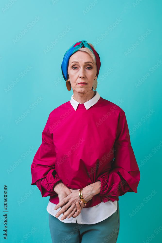 beautiful senior woman in retro style posing isolated on turquoise beautiful senior woman in retro style posing isolated on turquoise