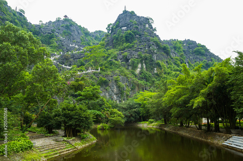 Hang Mua (Mua Cave), Vietnam - A trekking spot in Ninh Binh with impressive panoramic view of golden rice fields, limestone mountains along Ngo Dong river in Tam Coc photo