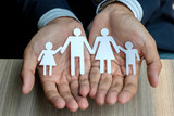 Businessman hands holding Family paper. Healthcare and Insurance concept