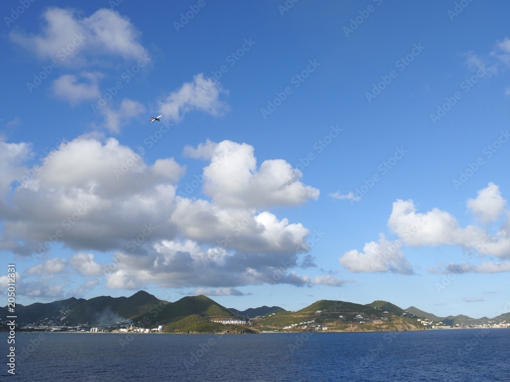 Coastal view of St. Thomas, US Virgin Islands with an airplane leaving the island on a bright day in March 2017. Hurricane Irma devastated St.Thomas in Sept. 2017.