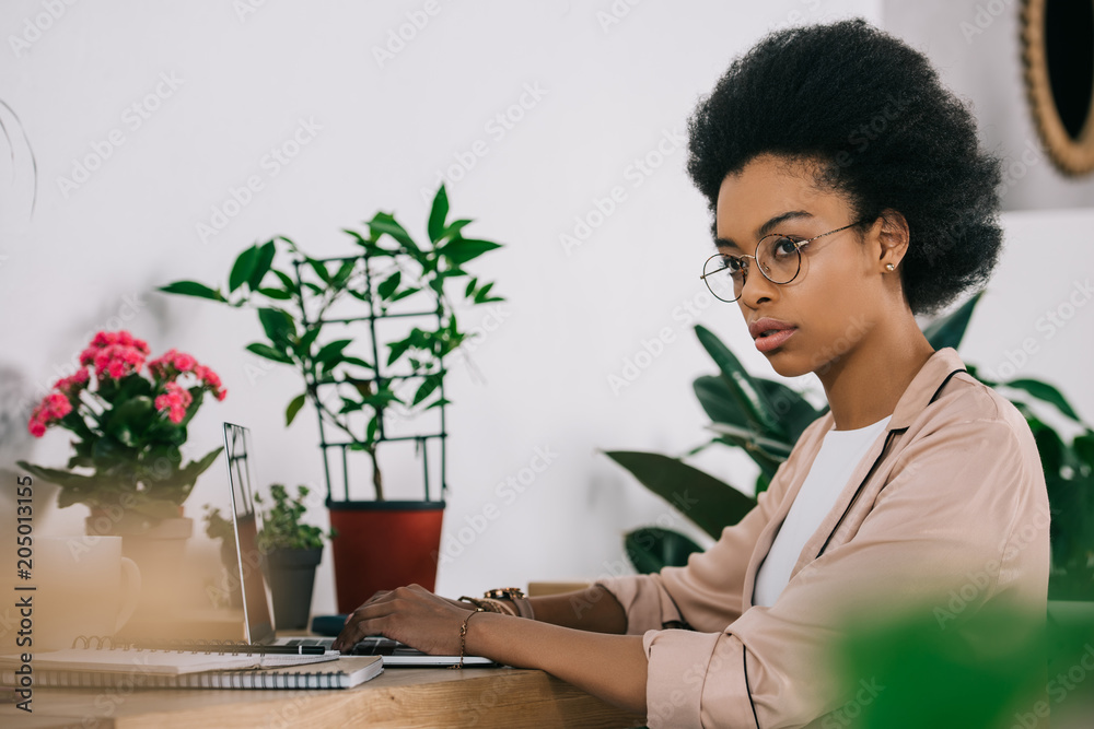 attractive african american businesswoman using laptop in office attractive african american businesswoman using laptop in office