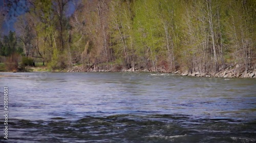 Bitterroot River running high with snow melt on a sunny spring morning in Montana