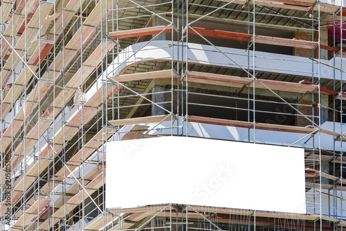 Blank space on a scaffolding building for your advertising. white mockup.