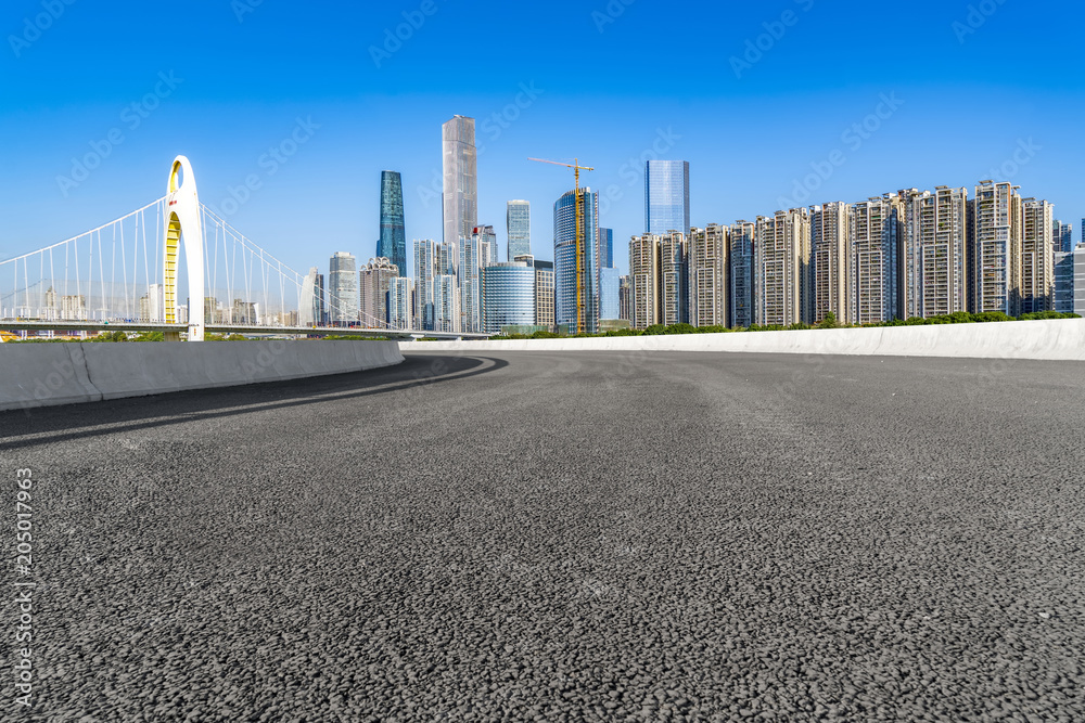 The empty asphalt road is built along modern commercial buildings in China's cities. The empty asphalt road is built along modern commercial buildings in China's cities.