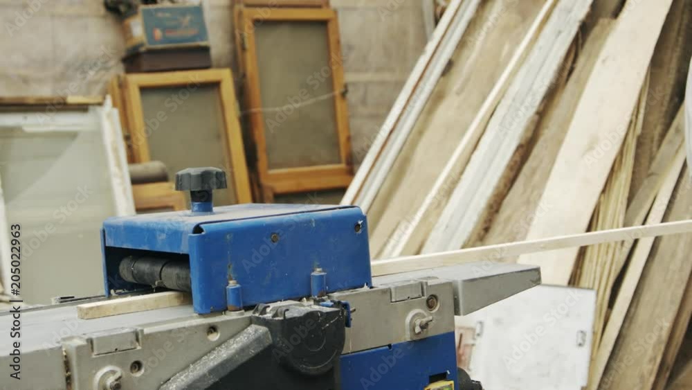 Slow motion shot of elderly man carpenter builds a small boat with his hands out of wood in a small workshop Slow motion shot of elderly man carpenter builds a small boat with his hands out of wood in a small workshop
