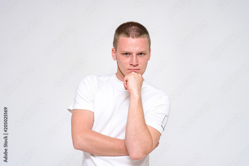 Portrait of a pensive young handsome man on a white background. Portrait of a pensive young handsome man on a white background.