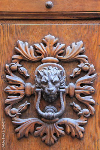 Door knocker in Montalcino town, Val d'Orcia, Tuscany, Italy