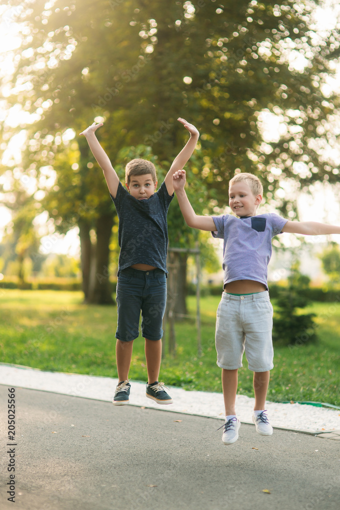 Obraz premium Two children are jumping up in the air