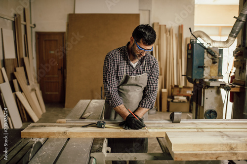 Skilled Carpenter craftsman at work in his workshop