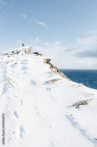 Lonely man silhouette on mountain peak. Latrabjarg  Iceland