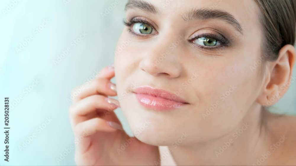 Pretty girl with clean skin big eyes and dark eyebrows looking at camera. Close-up concept Pretty girl with clean skin big eyes and dark eyebrows looking at camera. Close-up concept