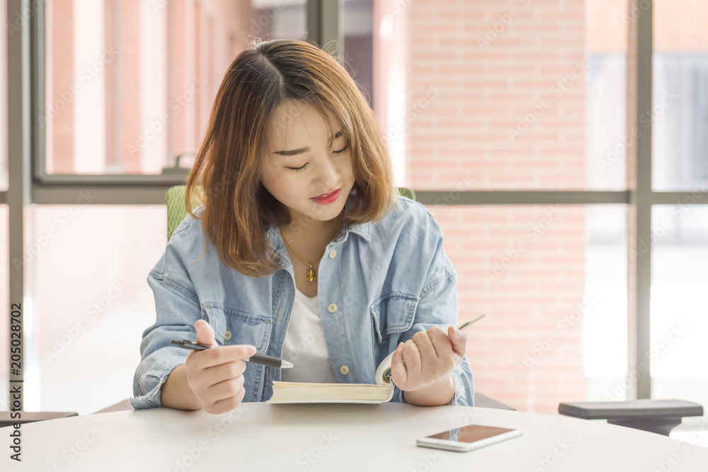 Asian student studying. A portrait of college student at campus Asian student studying. A portrait of college student at campus
