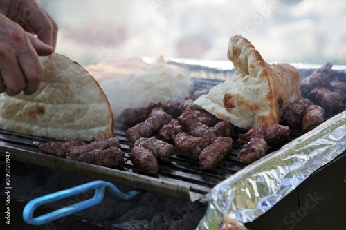 Cevapi (Cevapcici), Bosnian dish prepared on the barbecue and served with Lepinja bread. This dish is popular all over the Balkans, with tourists and locals.
