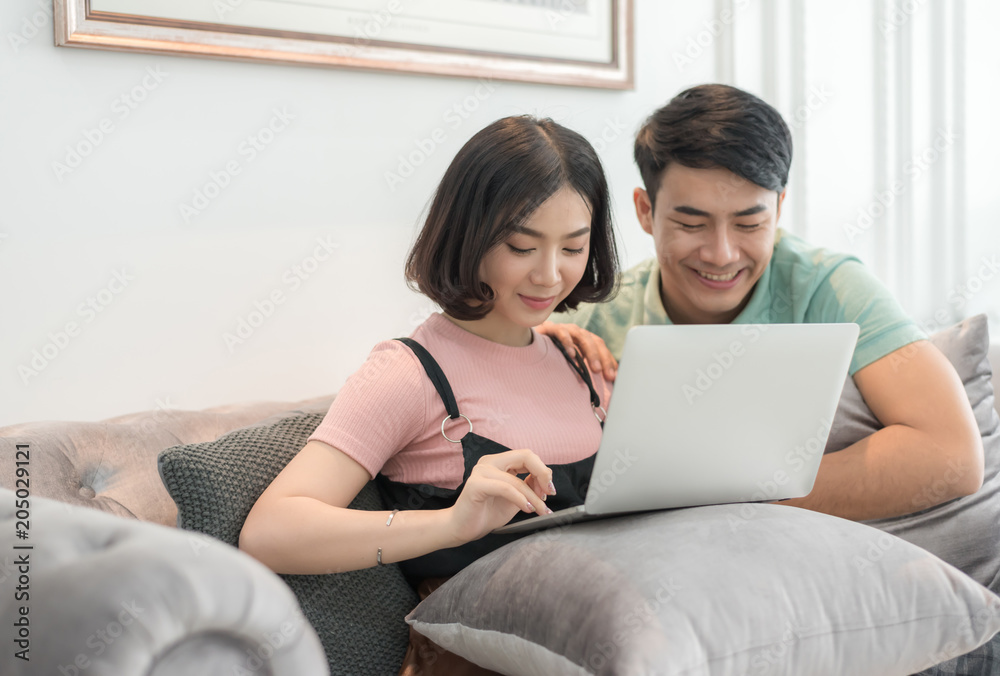 Couple Use Laptop Computer Together In Living Room, Happy Smiling Woman, Couple Use Laptop Computer Together In Living Room, Happy Smiling Woman,