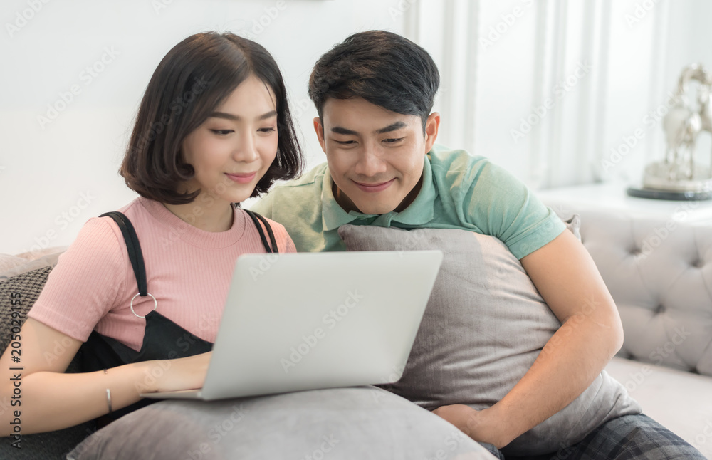 Happy Couple Use Laptop Computer Together In Living Room, Happy Smiling Woman, Happy Couple Use Laptop Computer Together In Living Room, Happy Smiling Woman,