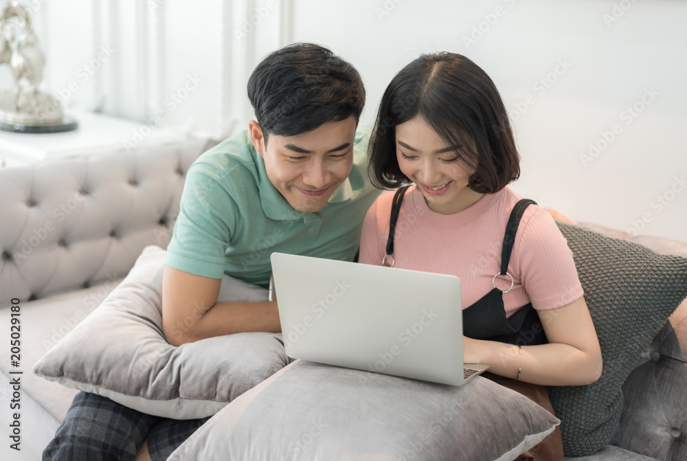Couple Use Laptop Computer Together In Living Room, Happy Smiling Woman, Couple Use Laptop Computer Together In Living Room, Happy Smiling Woman,