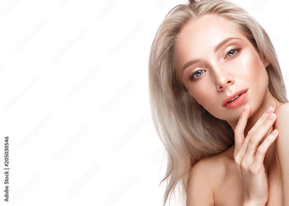 Fototapeta premium Beautiful young girl with a light natural make-up and perfect skin. Beauty face. Picture taken in the studio on a white background.