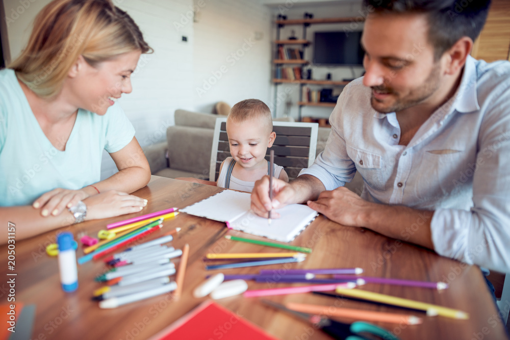 Young parents with young child draw Young parents with young child draw