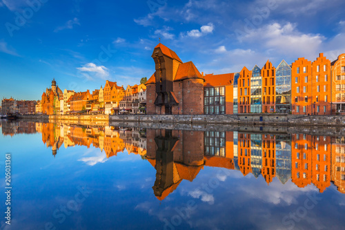 Historic port crane of Gdansk reflected in Motlawa river at sunrise, Poland