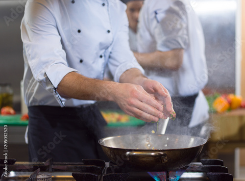 chef preparing food, frying in wok pan