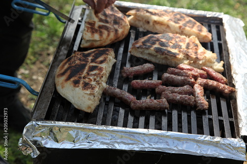 Cevapi (Cevapcici), Bosnian dish prepared on the barbecue and served with Lepinja bread. This dish is popular all over the Balkans, with tourists and locals.