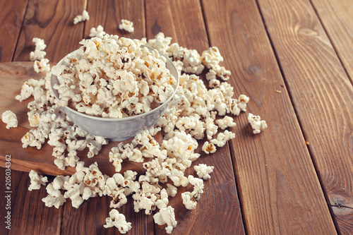 Salt popcorn on the wooden table