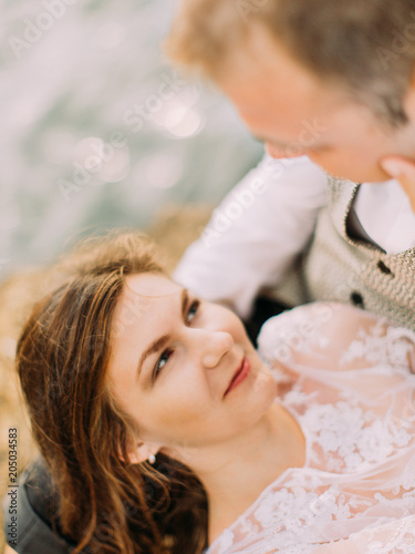 The above portrait of the bride lying on the laps of the groom. photo