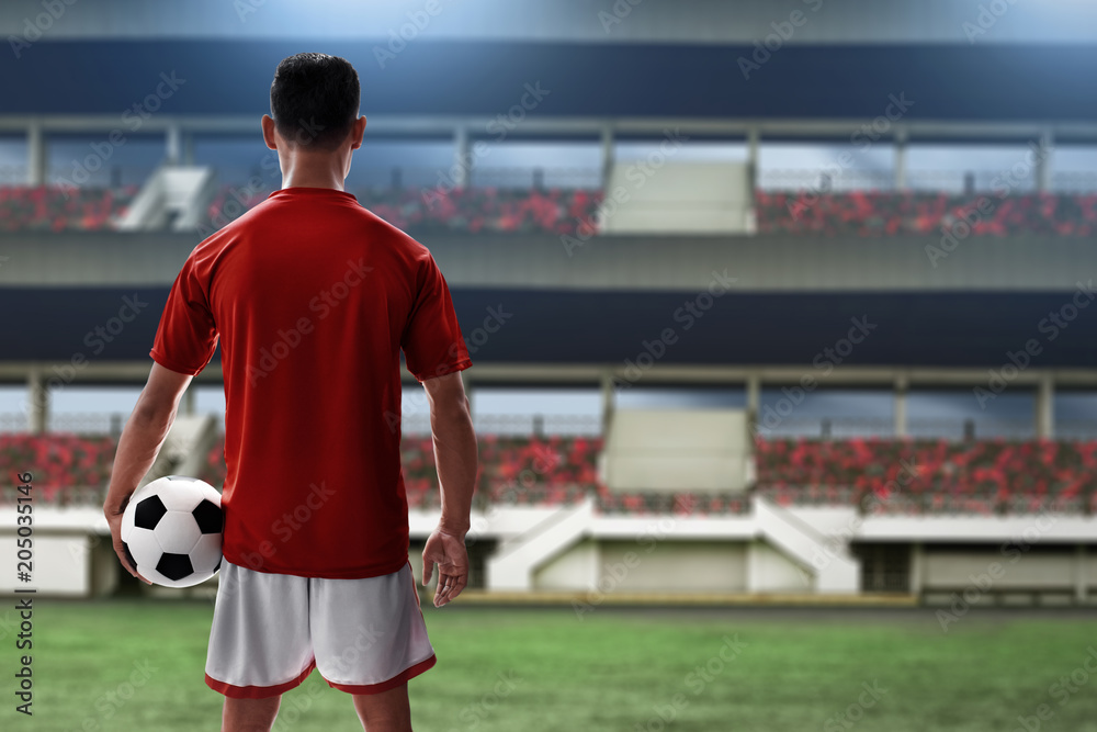 Fototapeta premium Soccer player holding soccer ball