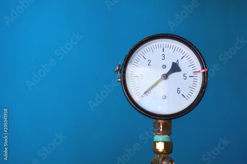A pressure gauge for pressure shows zero on a blue background. Abstract background.