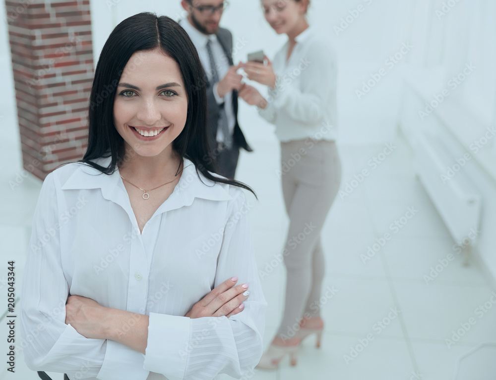 successful young business woman against the background of colleagues. successful young business woman against the background of colleagues.