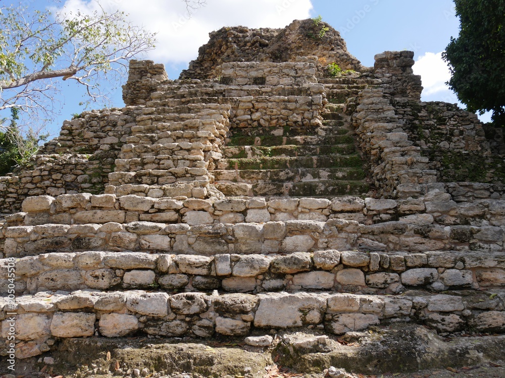 Front view of the stone steps of an old stone pyramid in Limones, one of the Mayan ruins at Mexico Highway 307 in Costa Maya,Mexico. 