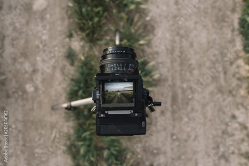 Vintage camera taking picture in field