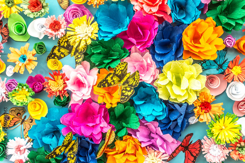 Bright paper artificial flowers as a background