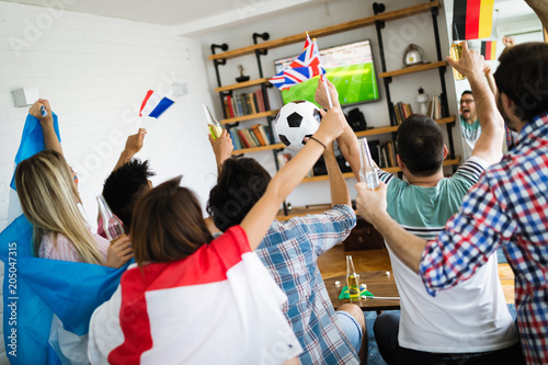 Group of multi-ethnic people celebrating football game