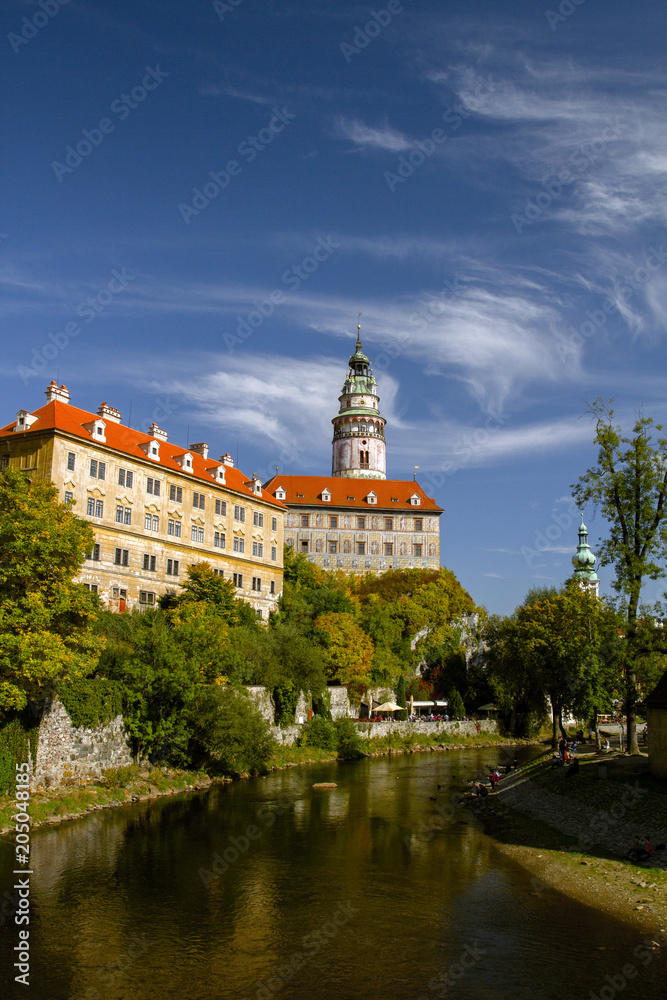 Cesky Krumlov, view on Vltava river and castle reflected in water in the  sunny day. Czech Republic.Historical city. UNESCO World View of Cesky Krumlov and the bridge./