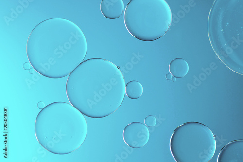 Water and oil on light blue background - Abstract macro
