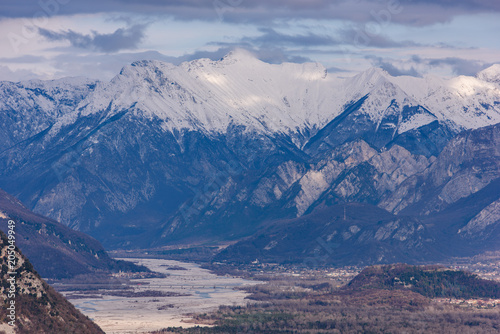The slow flow of the Tagliamento river cradled by its mountains.