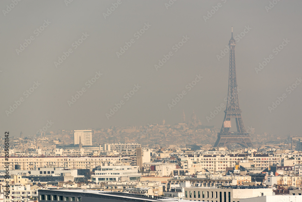Fototapeta premium Widok z lotu ptaka wieży Eiffla we mgle w Paryżu. Koncepcja zanieczyszczenia powietrza miasta