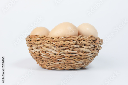 Wallpaper Mural Eggs in a nest basket on white background Torontodigital.ca