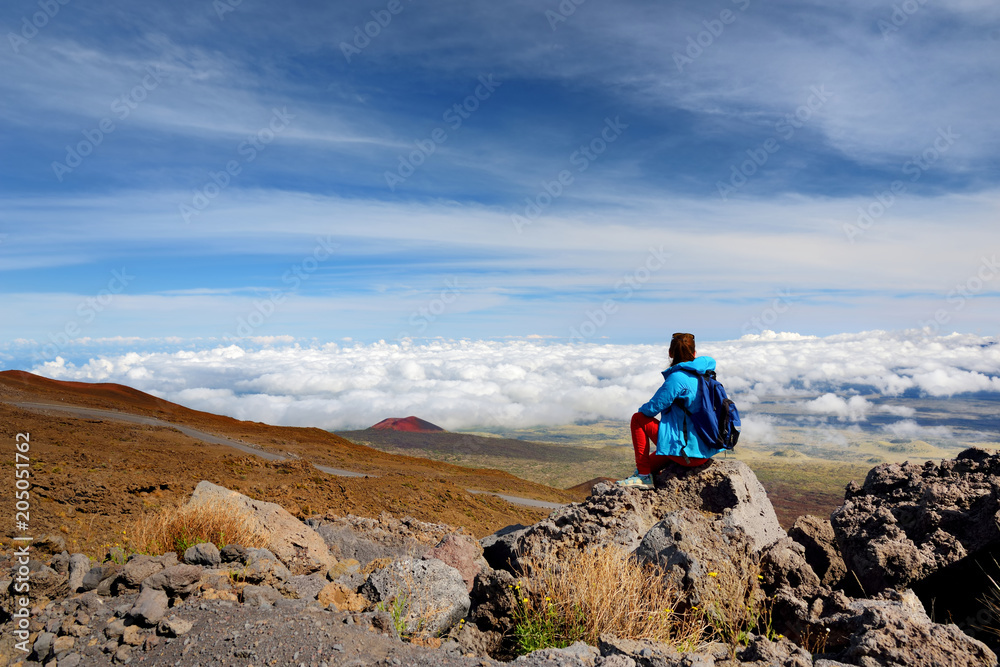 Tourist admiring breathtaking view of Mauna Loa volcano on the Big Island of Hawaii.
